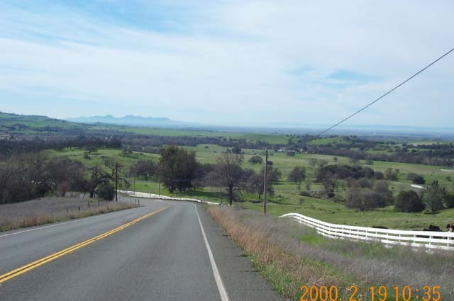 The Sutter Buttes are in the distance, with the green Paradise hills in the foreground.